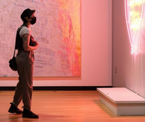 Visitor in Museum gallery viewing artwork