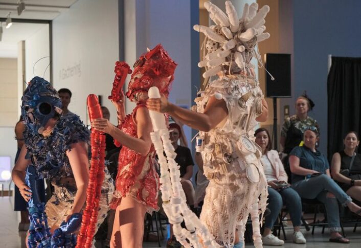 A runway show featuring costumes made with found trash and recyclables.