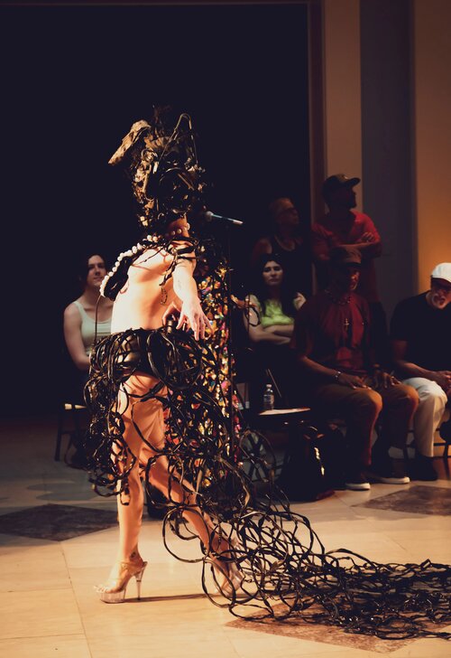 A runway show featuring costumes made with found trash and recyclables.