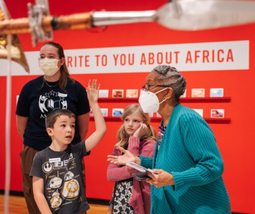 Elementary students engage with art and educators during a tour of an art museum