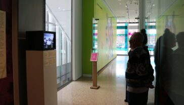 People viewing art work in the gallery.