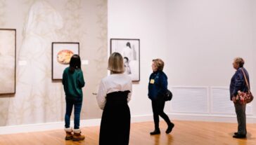 Guests walk through the exhibition space during the opening reception of 'Strange You Never Knew' a solo exhibition by Jarod Lew on Friday, January 31, 2025, at UMMA.