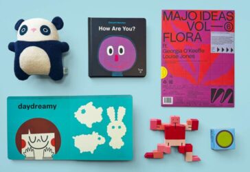 A light blue background with kids toys laid out from left to right; panda plushie, kids book with the title 'How Are You?, art kit, kids activity book titled 'daydreamy', robot figure and yoyo.