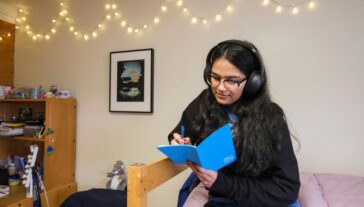 Original artworks from the Art at Home program displayed on the walls of student dorm rooms.