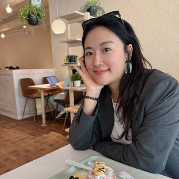 A woman seated in a coffee shop
