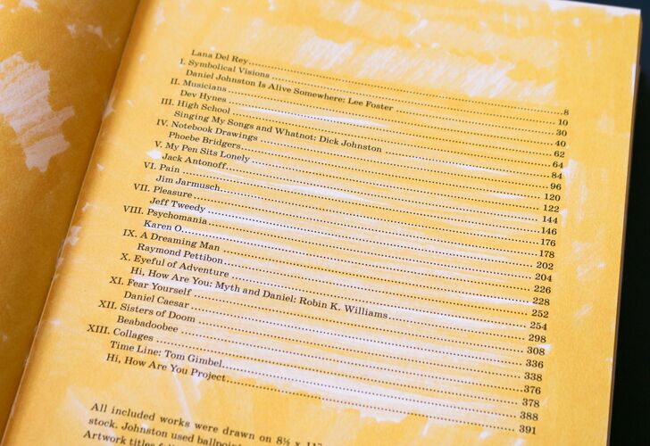 Open book displaying a table of contents with various chapter titles and page numbers, with names such as Robin K. Williams and Daniel Johnston mentioned.