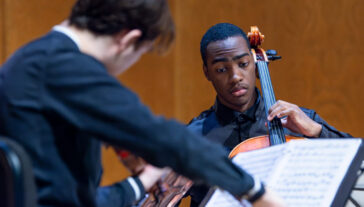 A person plays a cello