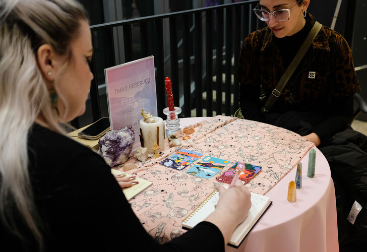 Visitors enjoy the activities at UMMA's Feel Good Friday Queer Night in February 2025, including Tarot Readings