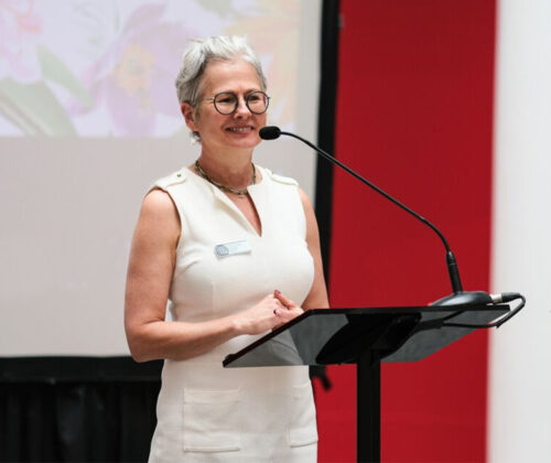 Photo of Christina Olsen speaking at a microphone for event at UMMA.