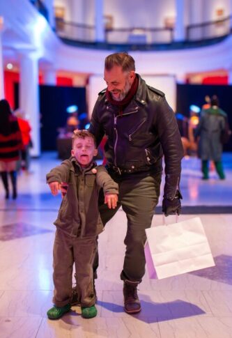 A father and child posing for the camera.