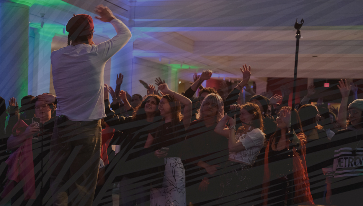 Inside the Apse of UMMA, a crowd watches Mato Wayuhi's performance at the "Feel Good Friday: Feel Good Frybread" event at UMMA on November 15, 2024.