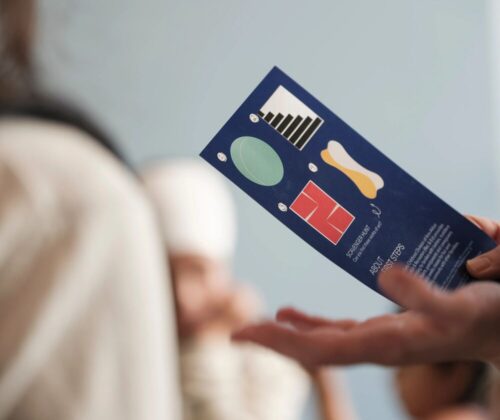 Person holding activity guide in gallery.