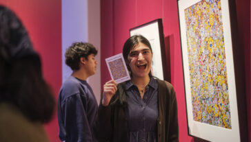 Students participate in Match Day for the "Art at Home" exhibition at UMMA, selecting original artworks from the gallery to take home for the winter semester as part of the Bridge Scholars Plus program.