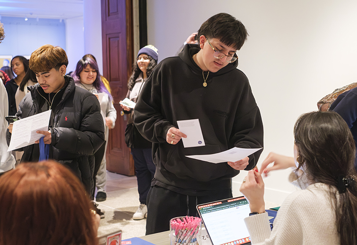 Students participate in Match Day for the "Art at Home" exhibition at UMMA, selecting original artworks from the gallery to take home for the winter semester as part of the Bridge Scholars Plus program.