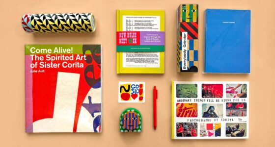 A flatlay of colorful books and stationery from the UMMA Shop on a peach background, including Sister Corita Kent-related books, a blue planner, a small notebook, a red pen, a Corita Kent sticker, a patterned water bottle, a boxed “Everybody Grinder,” and a Dusen Dusen kitchen timer.