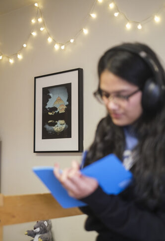 Original artworks from the Art at Home program displayed on the walls of student dorm rooms.