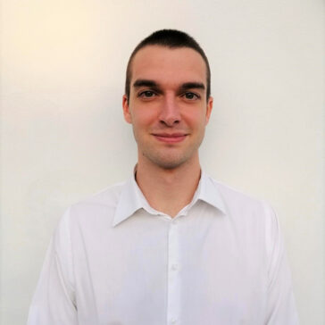 A portrait of a man in a white button-down top